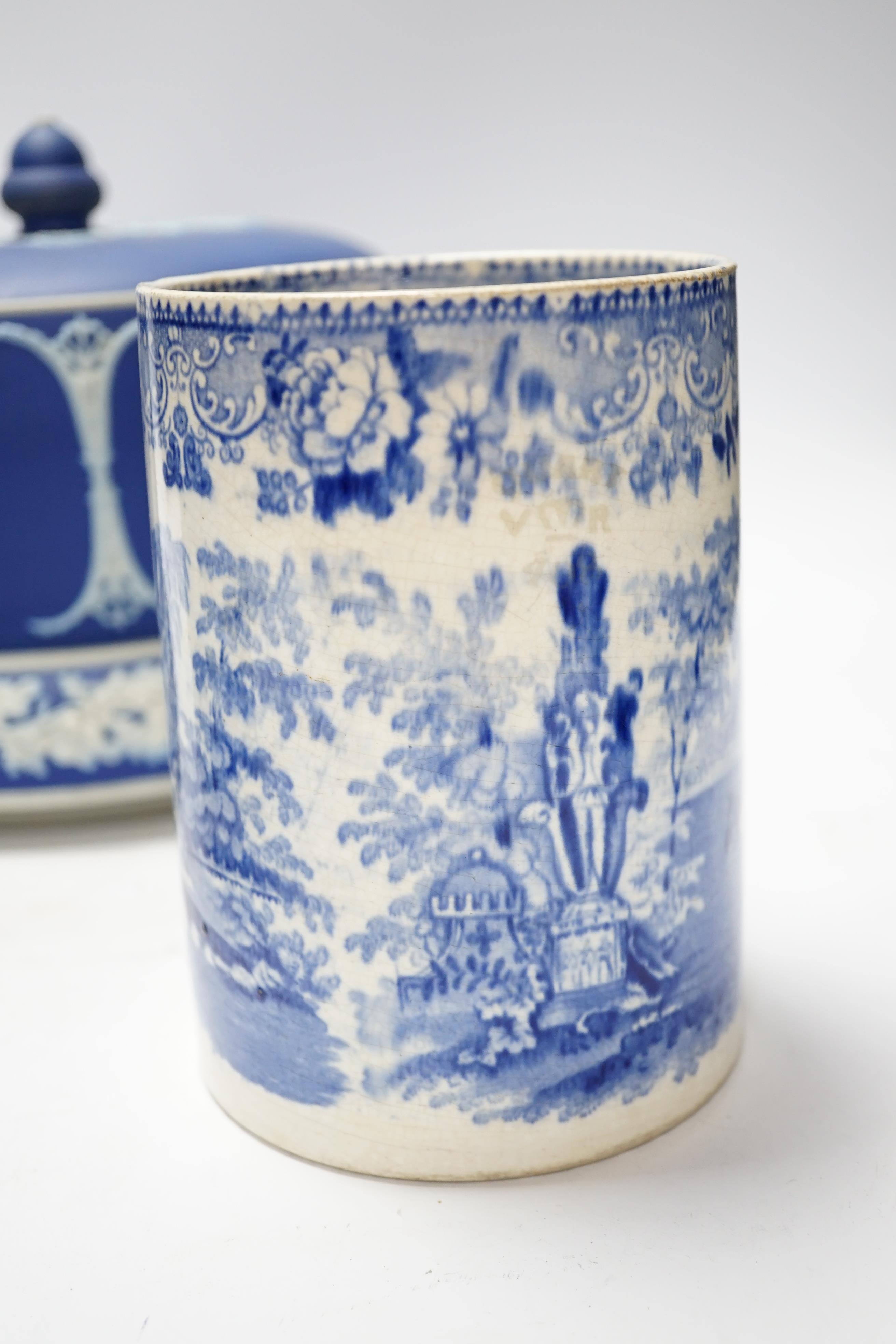 A Victorian Jasper ware cheese dome, a Wedgwood biscuit barrel and a transfer printed blue and white mug, largest 23cm in diameter